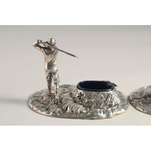 1369 - A PAIR OF SILVER PLATED GOLFER SALTS with blue liners.