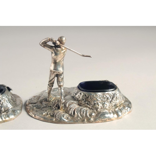 1369 - A PAIR OF SILVER PLATED GOLFER SALTS with blue liners.