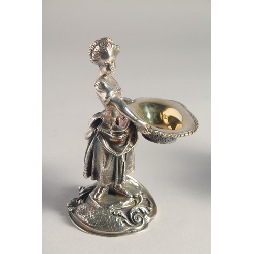 1370 - A PAIR OF SILVER PLATED YOUNG BOY AND GIRL SALTS both carrying baskets. 5.5ins high.