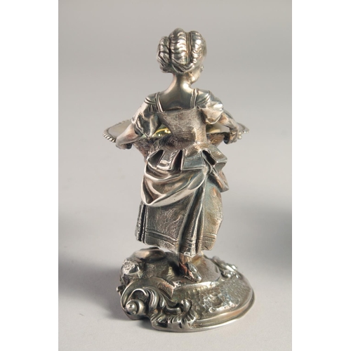 1370 - A PAIR OF SILVER PLATED YOUNG BOY AND GIRL SALTS both carrying baskets. 5.5ins high.