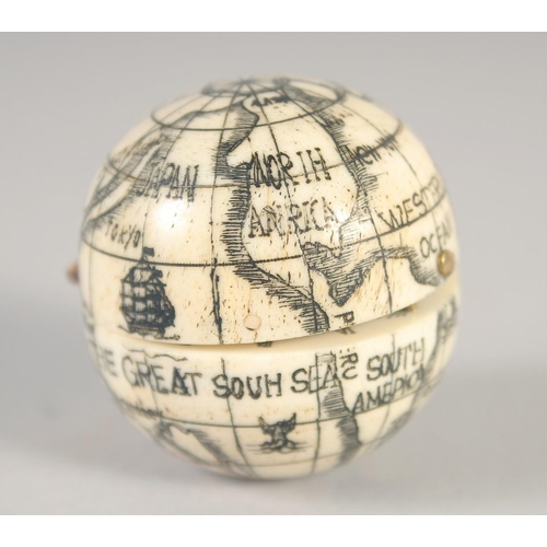 1390 - AN ETCHED BONE FOLDING GLOBE COMPASS. 1.5ins diameter.