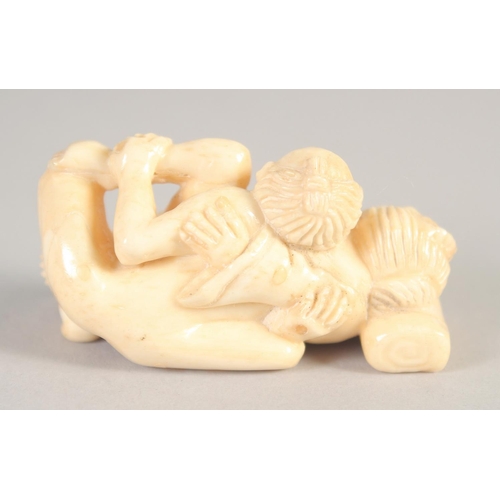 1396 - A SMALL CARVED BONE EROTIC NETSUKE. 2ins.