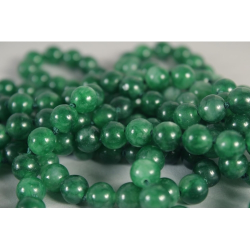 1397 - A LONG JADE STRING OF BEADS 50ins long.