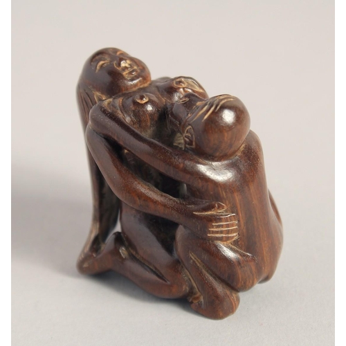 1400 - A CARVED WOOD EROTIC NETSUKE, signed. 1.5ins.