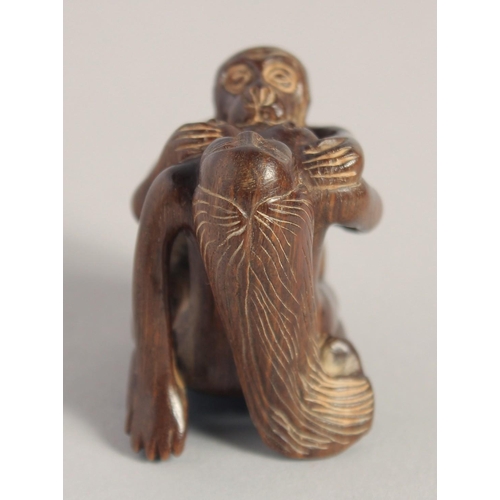 1400 - A CARVED WOOD EROTIC NETSUKE, signed. 1.5ins.