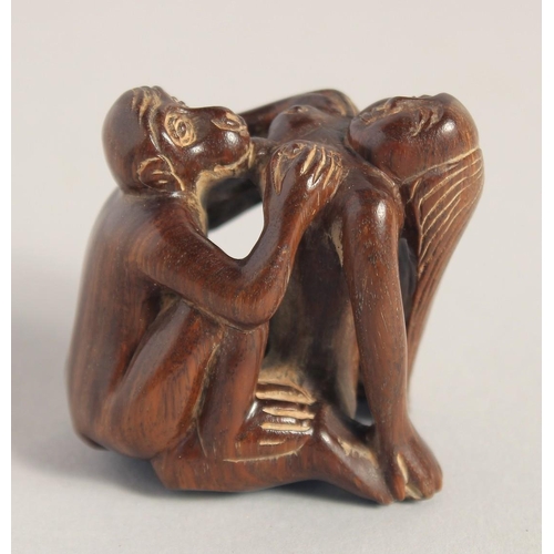 1400 - A CARVED WOOD EROTIC NETSUKE, signed. 1.5ins.