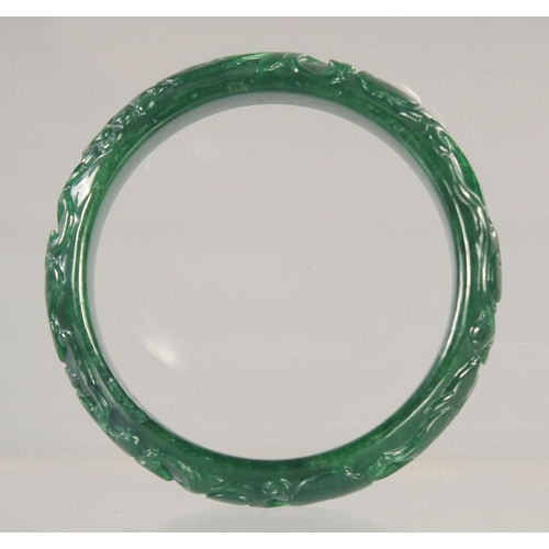 1413 - A CARVED JADE BANGLE. 2.75ins.