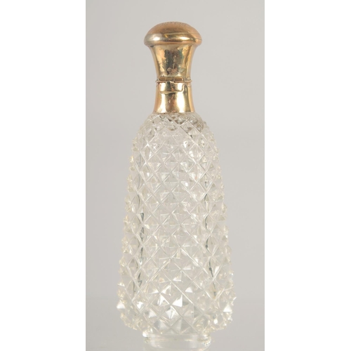 1417 - A CARVED CUT GLASS SCENT BOTTLE with 18ct gold top. 3.25ins.