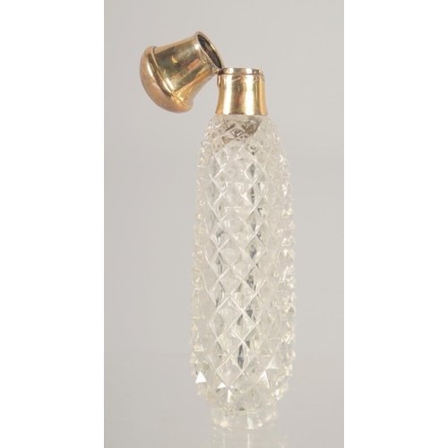 1417 - A CARVED CUT GLASS SCENT BOTTLE with 18ct gold top. 3.25ins.