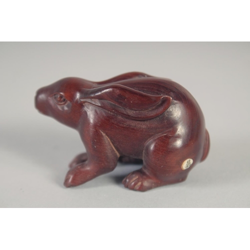 1421 - A JAPANESE CARVED WOOD RABBIT NETSUKE. Signed, 2ins.