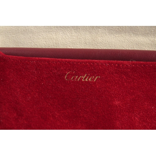 1434 - A CARTIER LEATHER WALLET in a red Cartier velvet case.