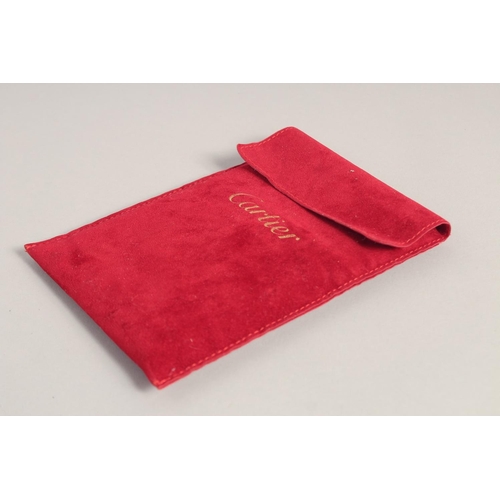 1434A - A CARTIER LEATHER WALLET in a red Cartier velvet case.