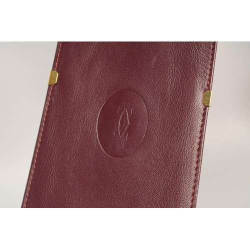 1435 - A CARTIER LEATHER CIGARETTE CASE in a red Cartier velvet case.