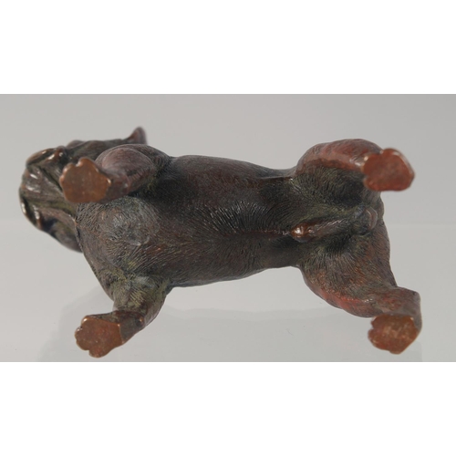 1438 - A CAST BRONZE MODEL OF A DOG. 7.5cm long.