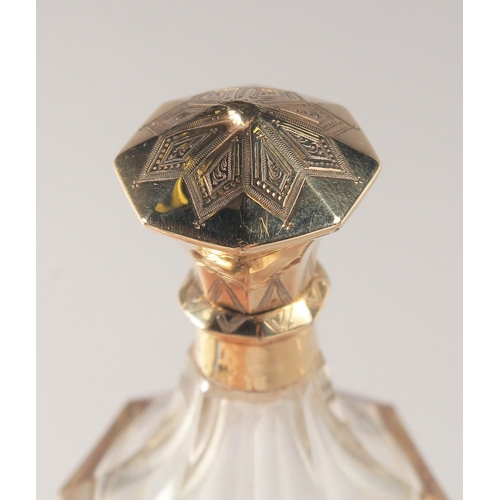 1441 - A CUT GLASS SCENT BOTTLE WITH HINGED GOLD TOP. 10cm high.