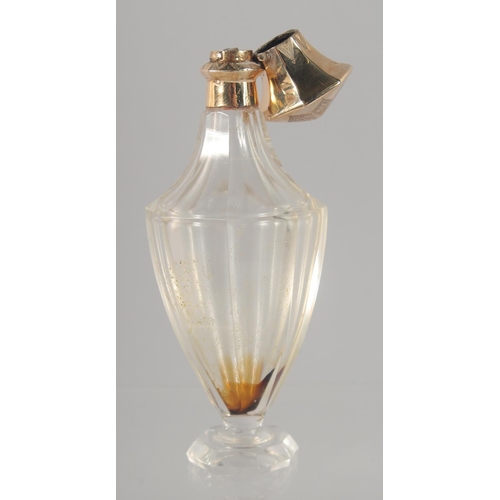 1441 - A CUT GLASS SCENT BOTTLE WITH HINGED GOLD TOP. 10cm high.