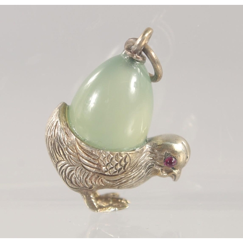 1457 - A SILVER AND JADE PENDANT, modelled as a chick carrying an egg on its back. 3cm high.