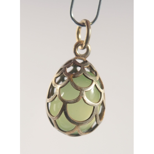 1458 - A SILVER AND JADE EGG SHAPED PENDANT, of cage design. 2cm high.