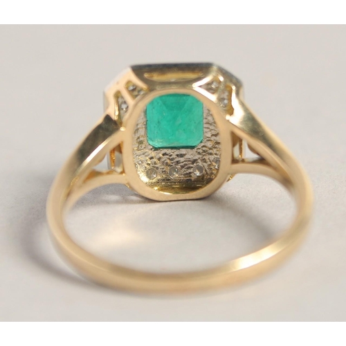 1544 - AN 18CT YELLOW GOLD COLUMBIAN EMERALD AND DIAMOND RING.