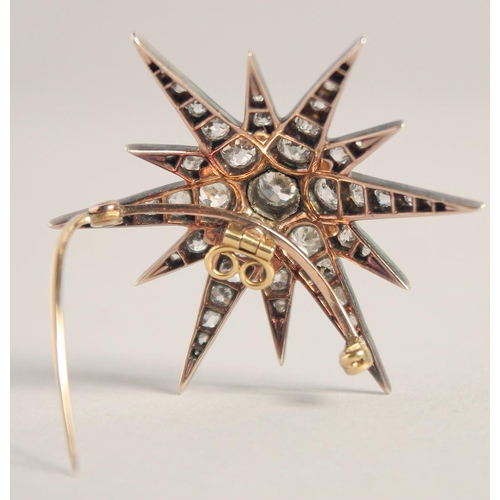 1555 - A GOOD VICTORIAN DIAMOND SET STAR BROOCH with central diamond, six medium diamonds and smaller diamo... 