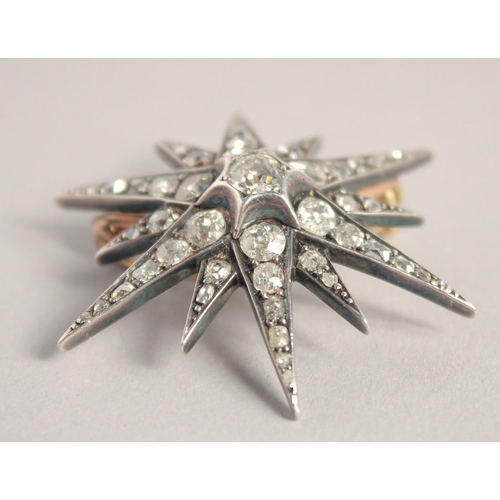 1555 - A GOOD VICTORIAN DIAMOND SET STAR BROOCH with central diamond, six medium diamonds and smaller diamo... 