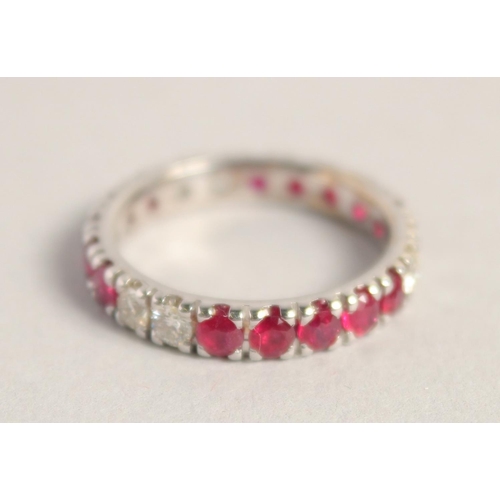 1556 - AN 18CT WHITE GOLD RUBY AND DIAMOND FULL ETERNITY RING.