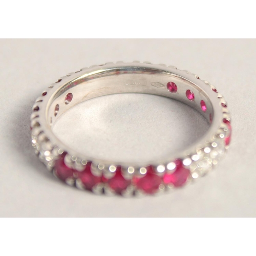 1556 - AN 18CT WHITE GOLD RUBY AND DIAMOND FULL ETERNITY RING.