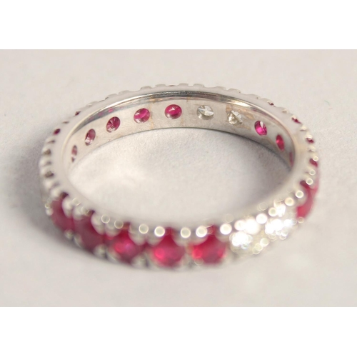 1556 - AN 18CT WHITE GOLD RUBY AND DIAMOND FULL ETERNITY RING.