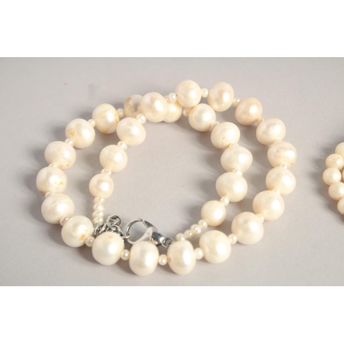 1572 - A LONG PEARL NECKLACE. 27ins and another. 15ins long (2).