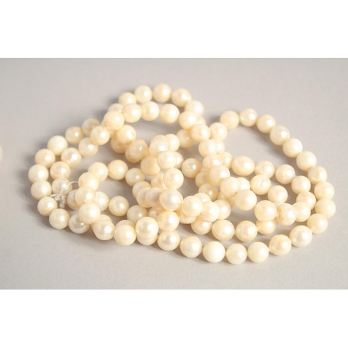 1572 - A LONG PEARL NECKLACE. 27ins and another. 15ins long (2).