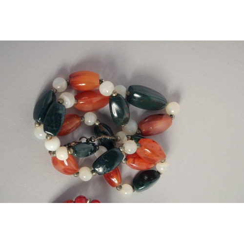 1573 - A TWO-COLOUR AGATE NECKLACE, THREE-COLOUR PEARL NECKLACE and an ORANGE STONE NECKLACE (3).