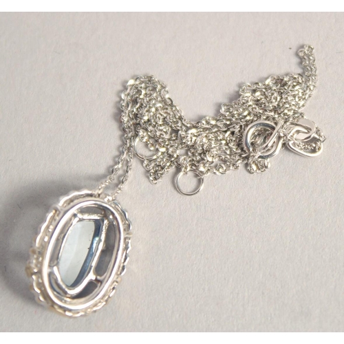 1581 - AN 18CT WHITE GOLD AQUAMARINE DIAMOND OVAL PENDANT on a chain,