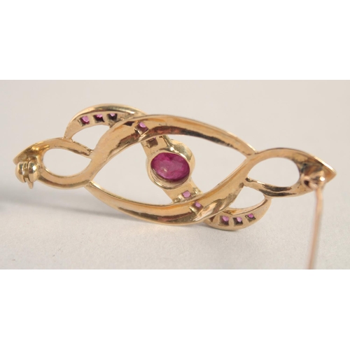 1596 - A 9CT GOLD RUBY SET BROOCH.