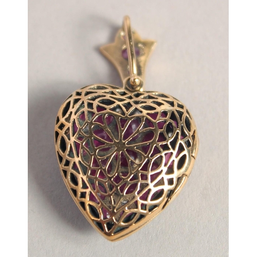 1605 - A 9CT GOLD RUBY AND DIAMOND HEART SHAPED LOCKET.