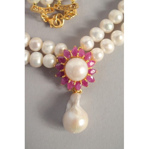 1608 - A PEARL NECKLACE with gold plated ruby and Baroque pearl clasp.