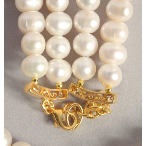 1608 - A PEARL NECKLACE with gold plated ruby and Baroque pearl clasp.