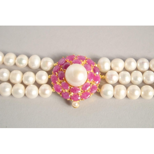 1609 - A PEARL BRACELET with GOLD PLATED RUBY CLASP.