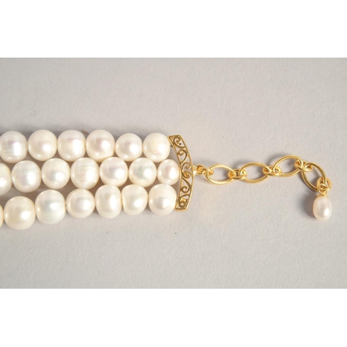 1609 - A PEARL BRACELET with GOLD PLATED RUBY CLASP.