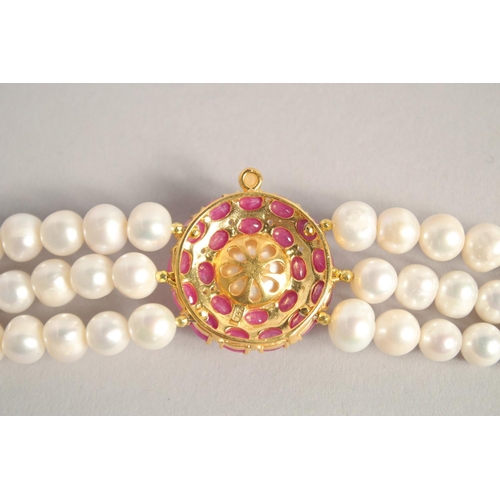 1609 - A PEARL BRACELET with GOLD PLATED RUBY CLASP.