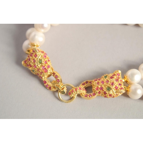 1610 - A PEARL NECKLACE with GOLD PLATED PANTHER CLASP.