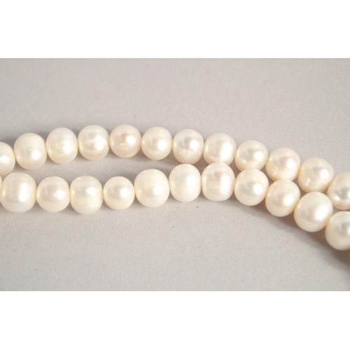 1610 - A PEARL NECKLACE with GOLD PLATED PANTHER CLASP.