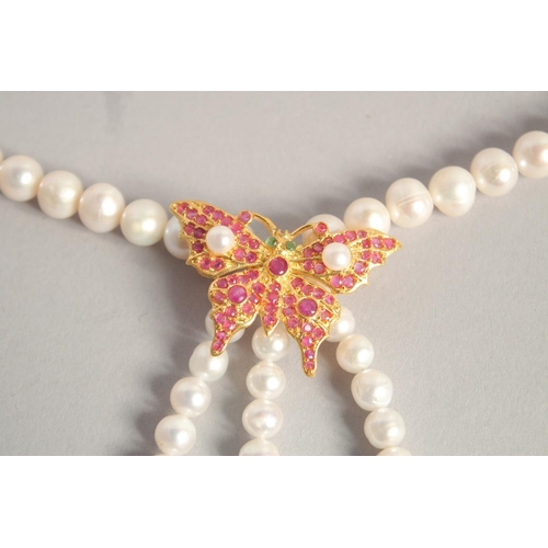 1611 - A PEARL NECKLACE with GOLD PLATED BUTTERFLY CLASP.