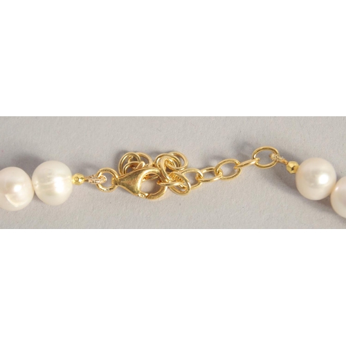 1611 - A PEARL NECKLACE with GOLD PLATED BUTTERFLY CLASP.