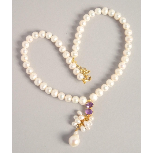 1613 - A PEARL NECKLACE with GOLD PLATED AMETHYST CLASP.