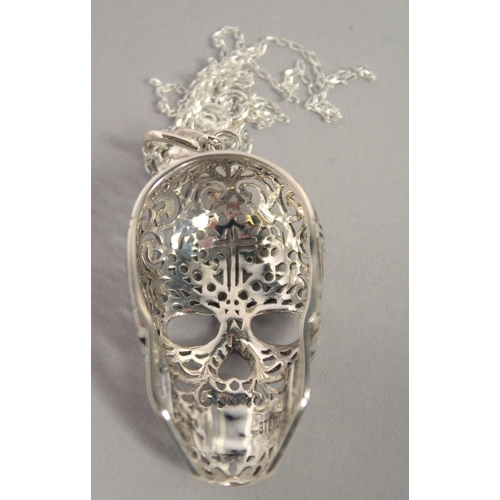 1616 - A SILVER FILIGREE SKULL PENDANT AND CHAIN.