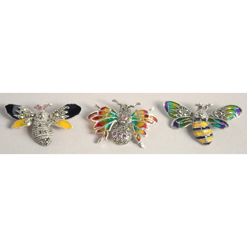 1627 - THREE SILVER AND ENAMEL BUG BROOCHES.