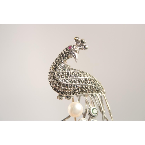 1633 - A SILVER EMERALD MARCASITE AND PEARL PEACOCK BROOCH.