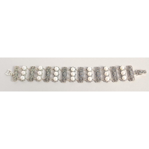 1637 - A SILVER PEARL AND MARCASITE WIDE BRACELET.