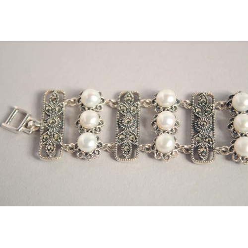 1637 - A SILVER PEARL AND MARCASITE WIDE BRACELET.