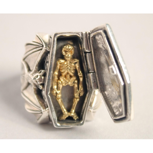 1639 - A SILVER AND BAT COFFIN RING.